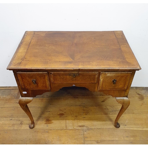 897 - A walnut lowboy, having three drawers, all raised on cabriole legs to pad feet, 91 cm wide