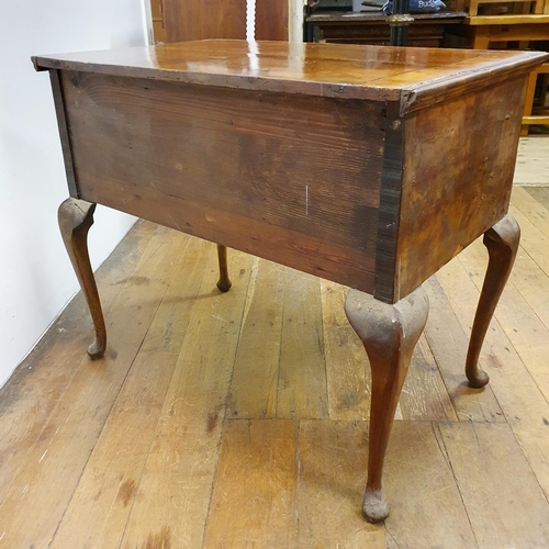 897 - A walnut lowboy, having three drawers, all raised on cabriole legs to pad feet, 91 cm wide