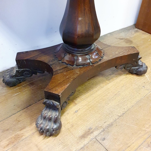 900 - A 19th century rosewood folding card table, on a column support to a shaped base, with lion paw feet... 