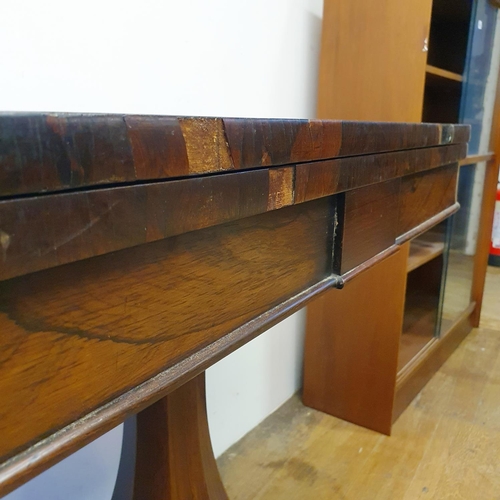 900 - A 19th century rosewood folding card table, on a column support to a shaped base, with lion paw feet... 