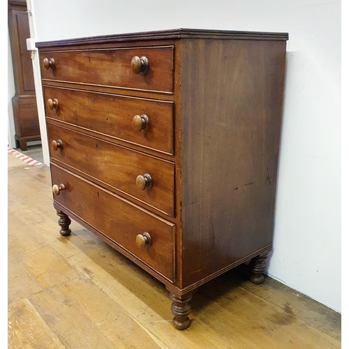 901 - A mahogany chest, having four drawers, on turned feet, 100 cm wide