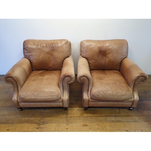 924 - A pair of light brown leather armchairs (2)