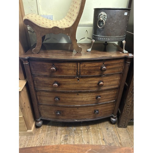 864 - A 19th century mahogany bow front chest, having two short and three long drawers, flanked by reeded ... 