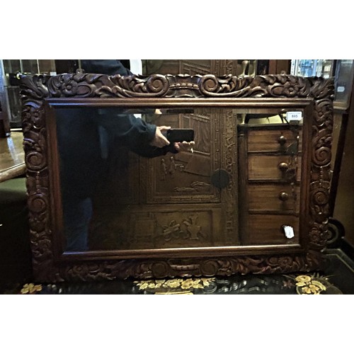 885 - A Chinese carved hardwood wall mirror, 87 x 60 cm