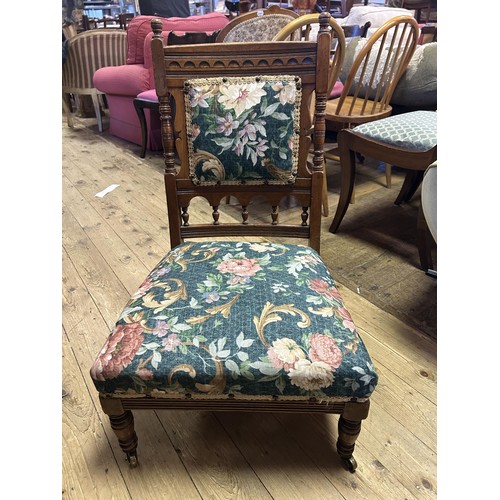 898 - A Gillows nursing chair, with a carved top rail, padded back and seat on turned legs, stamped Gillow... 