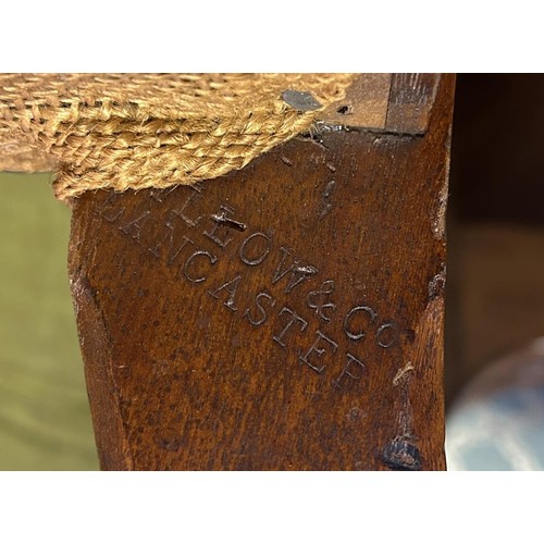 898 - A Gillows nursing chair, with a carved top rail, padded back and seat on turned legs, stamped Gillow... 