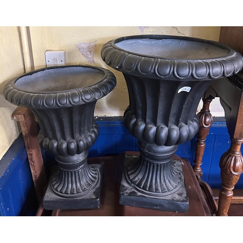 934 - A fiberglass urn, 62 cm high, another, 54 cm high, and three pedestals and assorted silk flowers (qt... 