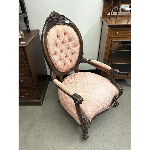 941 - A 19th century style mahogany framed open armchair, with a button back, padded arms and seat