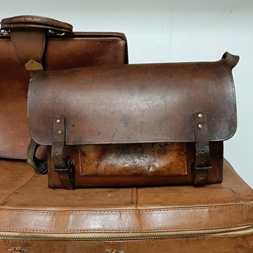 825 - A brown leather trunk, 91 cm wide, and three other cases (4)