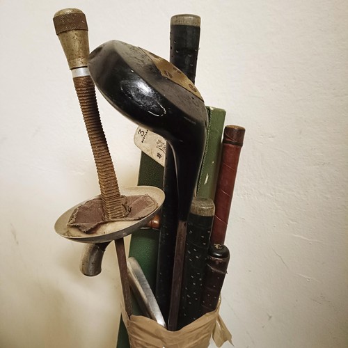 829 - A silver topped walking stick, various golf clubs, assorted sprays, and other items (qty)