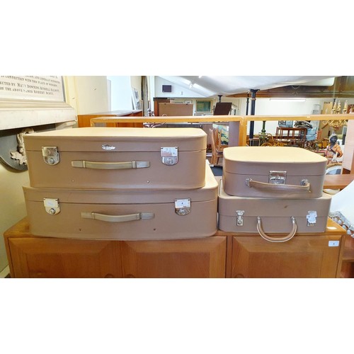 4 - A set of three 1950s Revelation suitcases, and a matching vanity case (4)