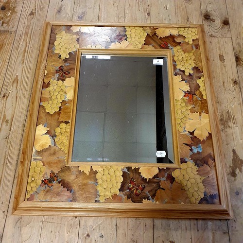 6 - A modern marquetry inlaid mirror, decorated grapes and butterflies, 68 x 80 cm