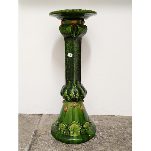 49 - A Bretby green glazed jardinière stand, 82 cm high