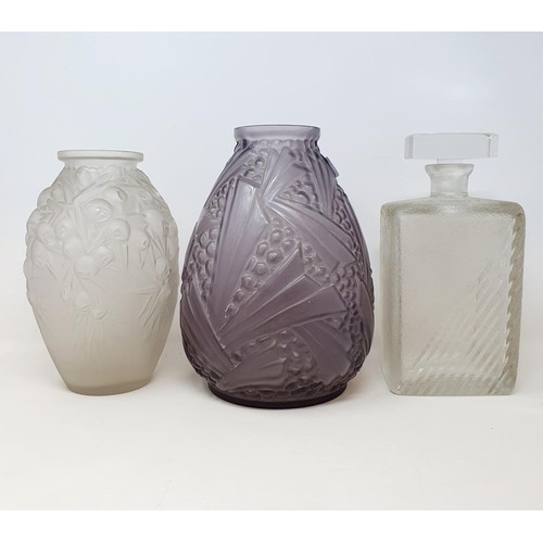 79 - A Lalique style frosted glass vase, 25 cm high, another in purple glass, 28 cm high, and a decanter,... 