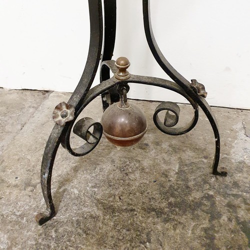 142 - A Dr Christopher Dresser style copper kettle, on a wrought iron stand,  85 cm high