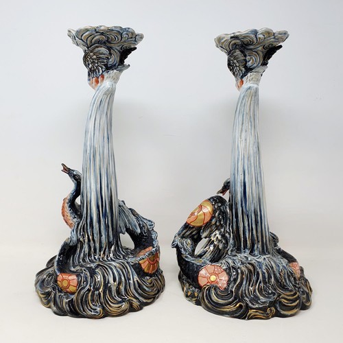 149 - A pair of Keller & Guerin candlesticks, the bases in the form of a sea creatures pursuing a bird, mo... 