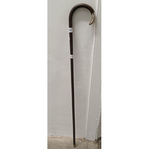 831 - An early 20th century walking stick, with a silver coloured metal mount, 90 cm long