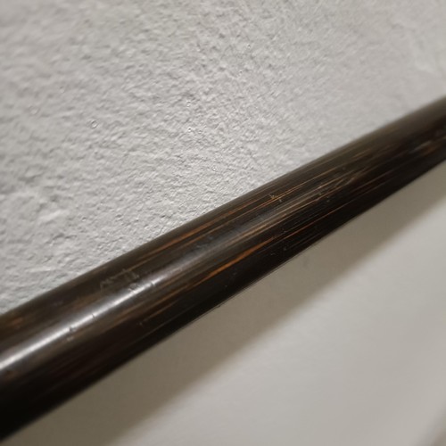 831 - An early 20th century walking stick, with a silver coloured metal mount, 90 cm long