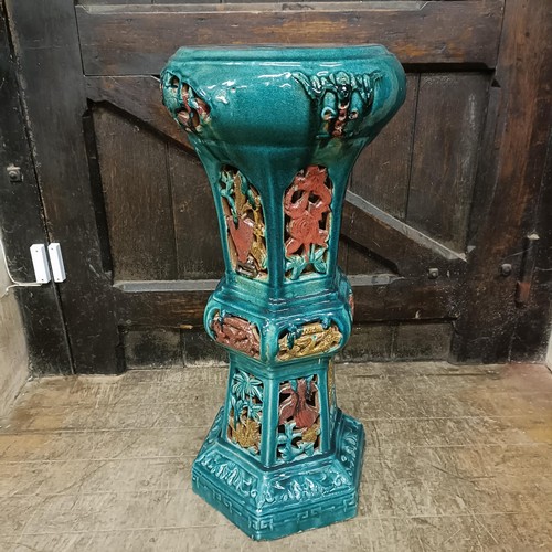 842 - A Chinese earthenware jardinière stand, with pierced decoration, 73 cm high