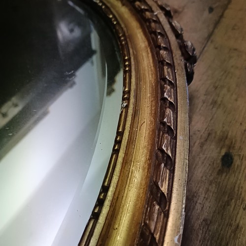 913 - An early 20th century gilt gesso oval wall mirror, 100 x 70 cm