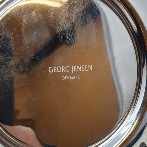 139 - A Georg Jensen chrome and glass candle holder, 20 cm diameter