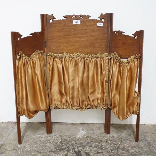 141 - An Arts & Crafts oak table screen, decorated mythical beasts, 69 cm high