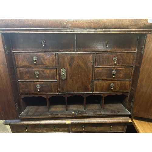 871 - An 18th century walnut cabinet on chest, the top with a drawer above two cupboard doors to reveal a ... 