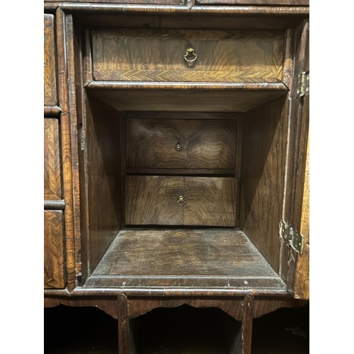 871 - An 18th century walnut cabinet on chest, the top with a drawer above two cupboard doors to reveal a ... 