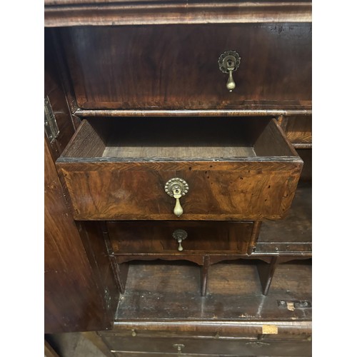 871 - An 18th century walnut cabinet on chest, the top with a drawer above two cupboard doors to reveal a ... 