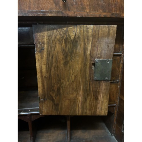 871 - An 18th century walnut cabinet on chest, the top with a drawer above two cupboard doors to reveal a ... 