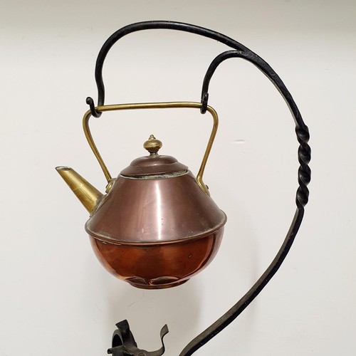 502 - A Dr Christopher Dresser style copper kettle, on a wrought iron stand,  85 cm high