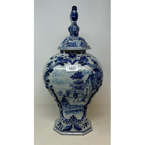 518 - A Delft blue and white vase and cover, the finial in the form of a parrot, 45 cm high