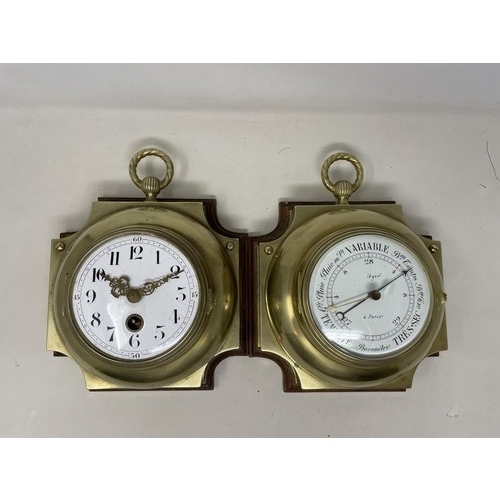 538 - A wall clock, the 11 cm diameter enamel dial with Arabic numerals, in a brass case mounted on an oak... 