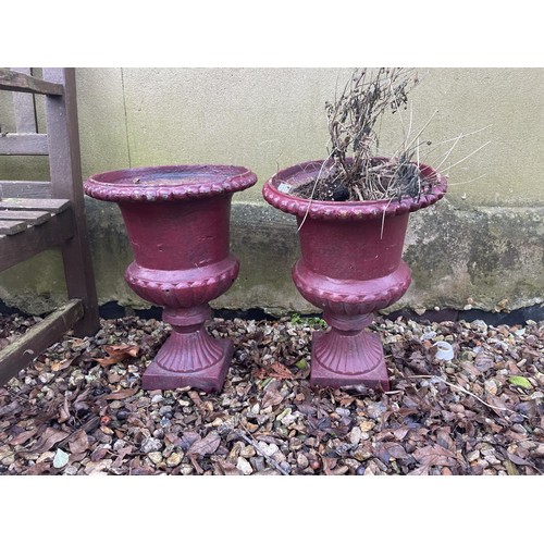 950 - A pair of painted cast iron garden urns, of campagna form, 45 cm high