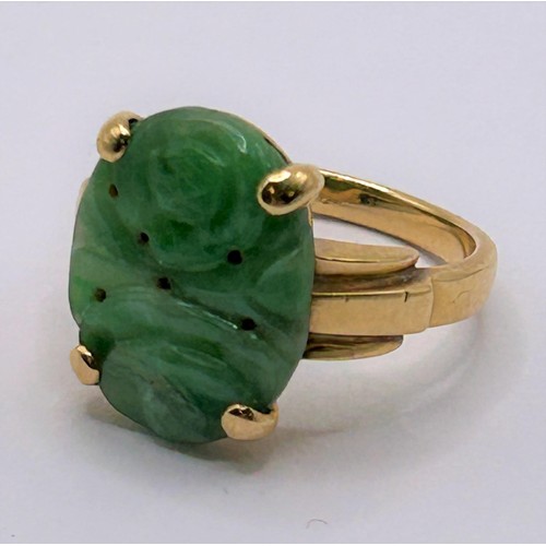 12 - A Chinese carved green stone ring, ring size L...