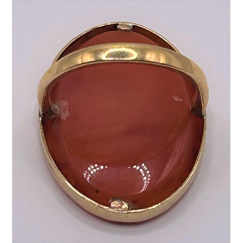 53 - A 9ct gold and carved red stone ring, ring size E...