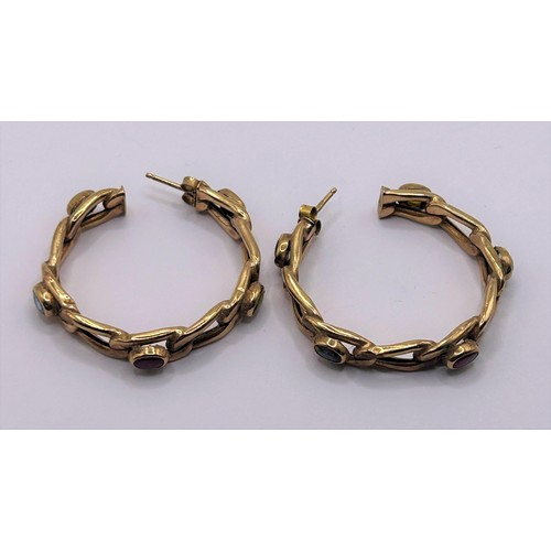 55 - A pair of yellow metal and multicoloured stone hoop earrings...