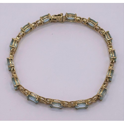 64 - A 9ct gold and aquamarine bracelet