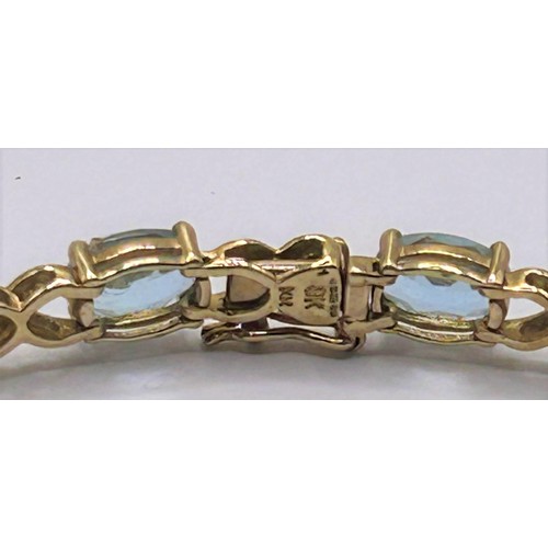 64 - A 9ct gold and aquamarine bracelet