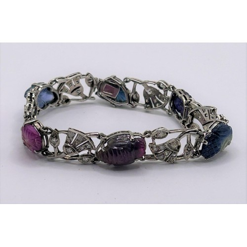 86 - An Art Deco style white coloured metal, diamond and carved hardstone bracelet, 18 cm wide