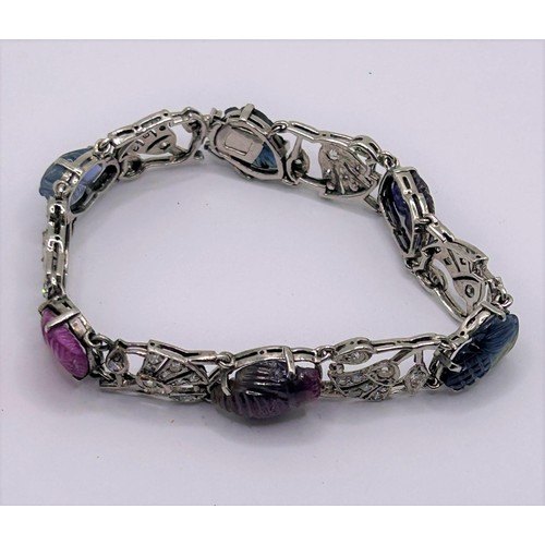 86 - An Art Deco style white coloured metal, diamond and carved hardstone bracelet, 18 cm wide