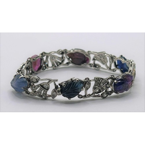 86 - An Art Deco style white coloured metal, diamond and carved hardstone bracelet, 18 cm wide