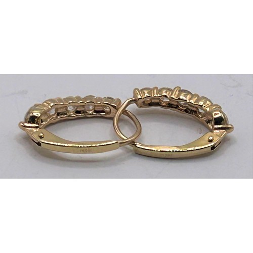 116 - A pair of 18ct gold and diamond earrings