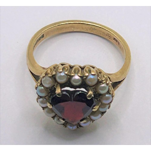 125 - A 9ct gold, garnet and seed pearl ring, ring size L