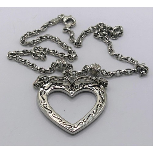 157 - An 18ct white gold and diamond heart shaped pendant, on a chain