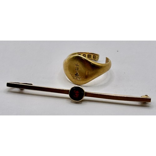 27 - An 18ct gold signet ring, cut, and a 9ct gold and garnet tie pin, 6.1 g...
