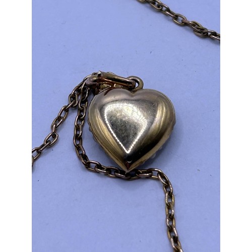 105 - A yellow coloured metal, seed pearl and turquoise heart shaped pendant, on a chain