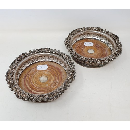 263 - A pair of silver plate bottle coasters, 16 cm diameter