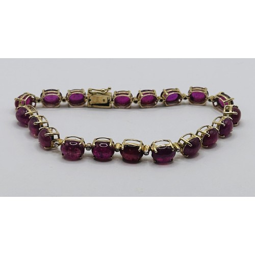 22 - A 9ct gold and cabochon red stone bracelet...