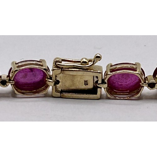 22 - A 9ct gold and cabochon red stone bracelet...